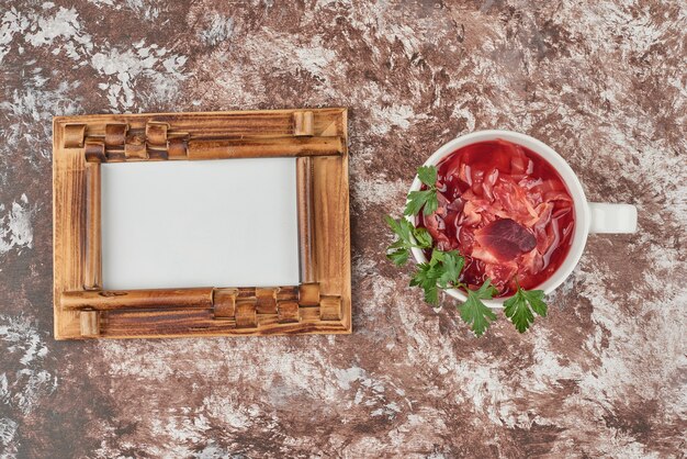 Photo gratuite soupe de légumes rouges dans une tasse blanche