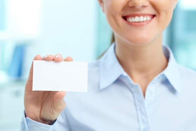 Sourire d&#39;affaires avec une carte de visite vierge