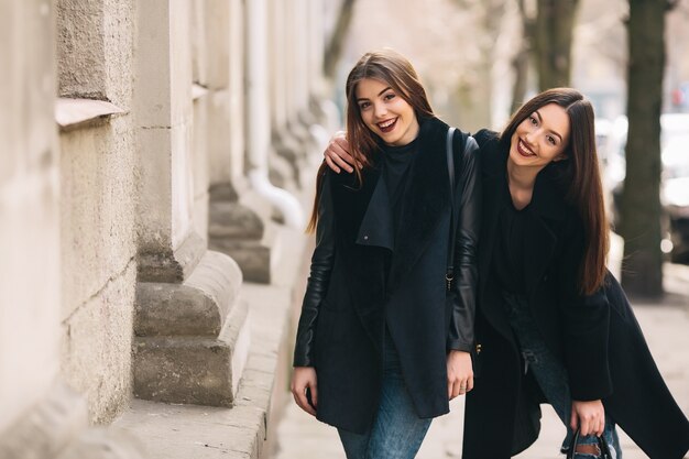 Sourire amis marchant dans la rue