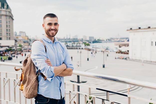 Photo gratuite sourire, homme, à, bras croisé, debout, près, balustrade, regarder caméra