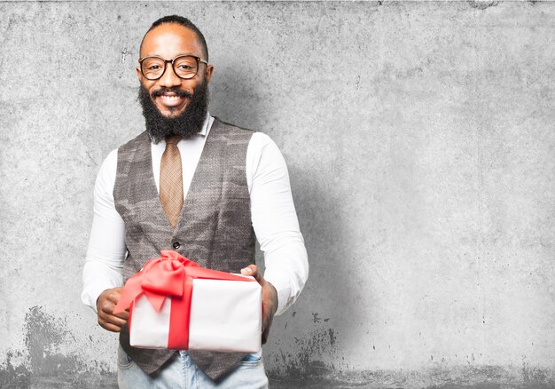 Sourire homme avec un cadeau blanc avec noeud rouge