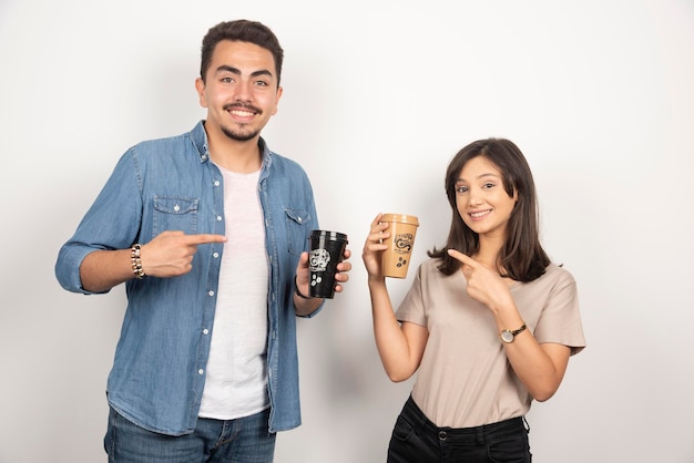 Sourire homme et femme avec des tasses de café.