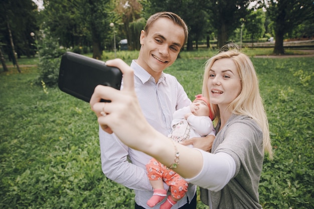 Sourire jeune femme de prendre une photo avec sa famille