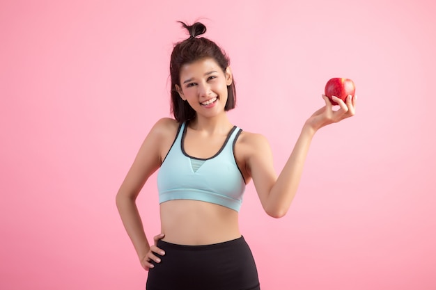 Sport femme en bonne santé tenant une pomme rouge