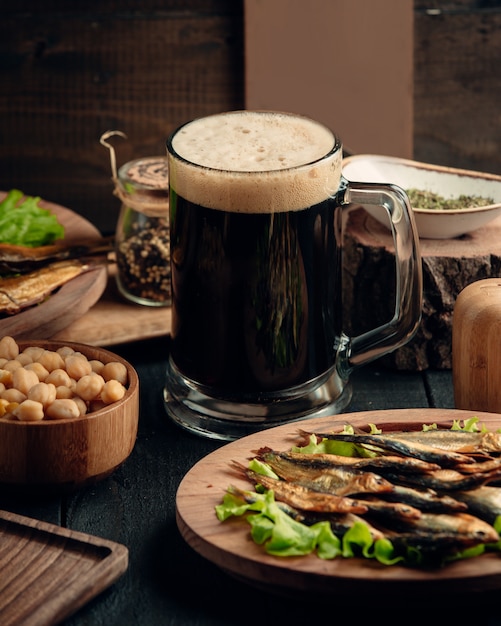 Photo gratuite sprat fumé, pois chiches bouillis servis avec une chope de bière