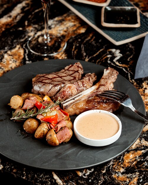 Steak de boeuf grillé servi avec plat de pommes de terre et sauce aux champignons