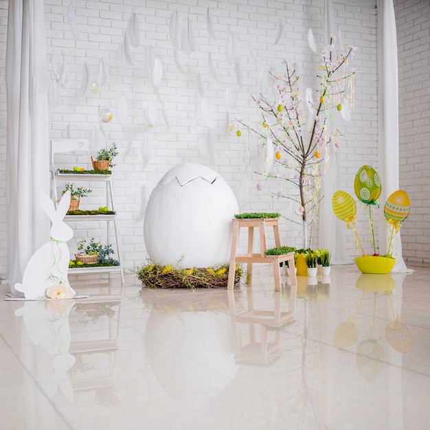Studio lumineux préparé pour Pâques et décoré avec des oeufs et de la verdure