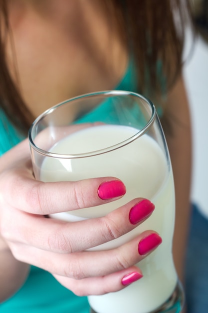 Studio Portrait d&#39;une belle jeune femme avec un verre de lait