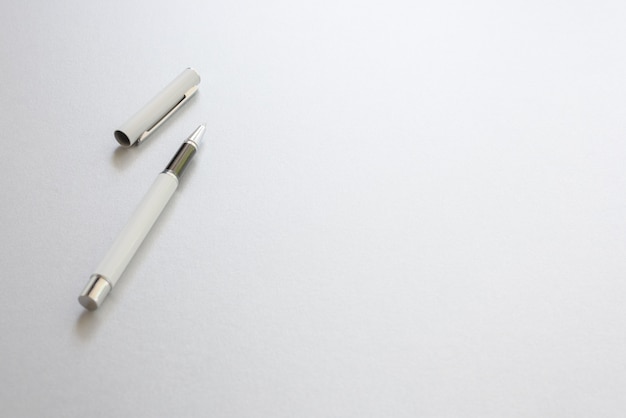 Un Stylo Blanc Isolé Sur Papier D'écriture Blanc, Fond.