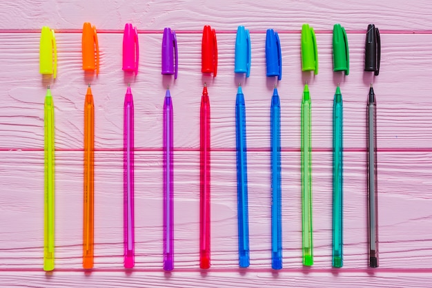 Photo gratuite stylos multicolores sur table rose