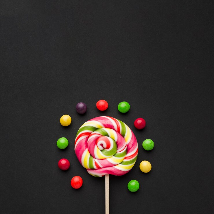Photo gratuit sucette et bonbons sur tableau noir