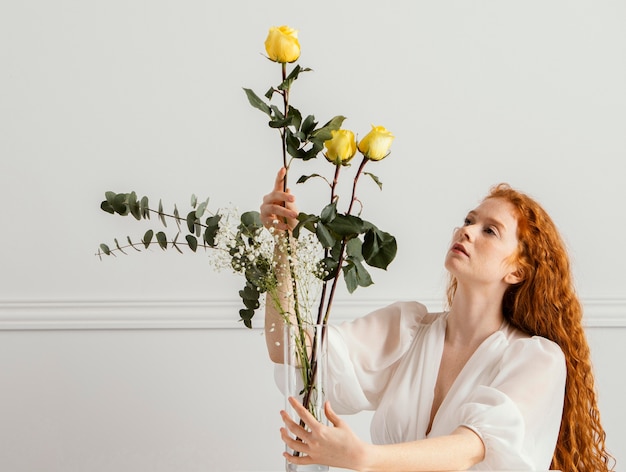 Superbe femme posant avec des fleurs de printemps