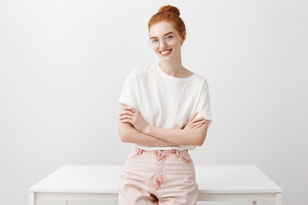 Superbe femme rousse se penche sur la table et à la confiance