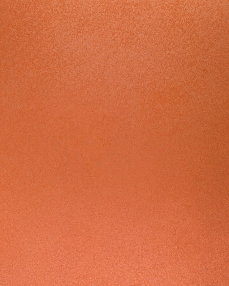 Photo gratuit surface du mur en béton orange grossier