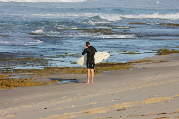 Surfeur entrant dans la mer