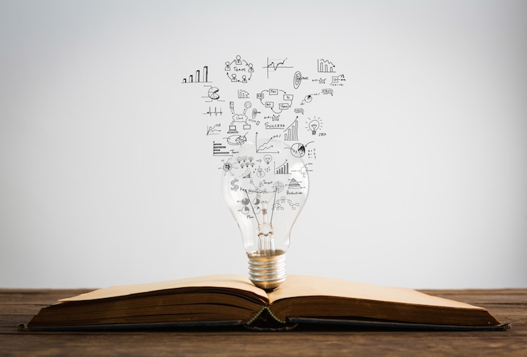 Photo gratuit symboles sortent d'une ampoule au-dessus d'un livre