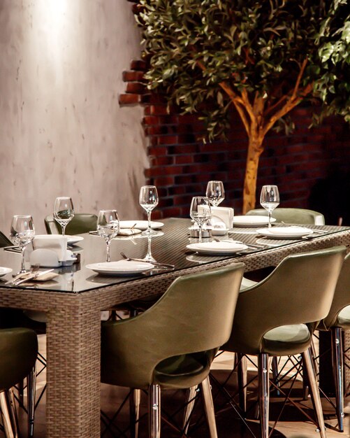 Table en osier gris avec des chaises en verre et gris