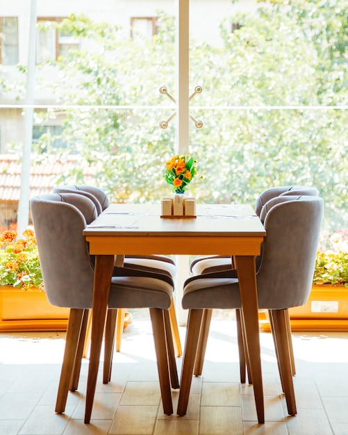 Photo gratuite table pour quatre personnes devant la fenêtre du restaurant