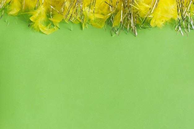 Table verte avec des plumes jaunes sur le dessus