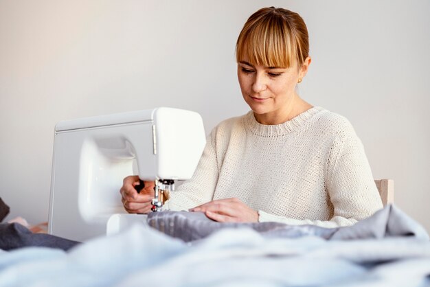 Tailleur femme à l'aide de machine à coudre