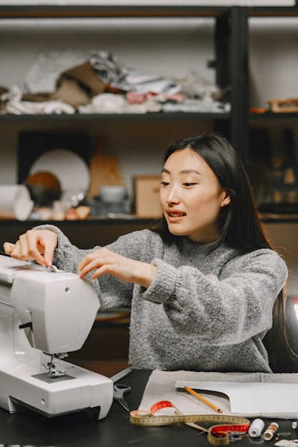 Photo gratuite tailleur de femme coréenne asiatique dans un atelier de couturière travaillant