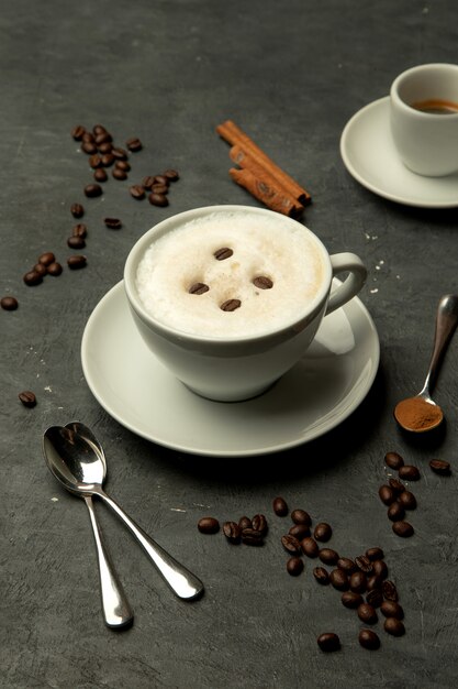 Une tasse de café au lait mousseux garnie de grains de café