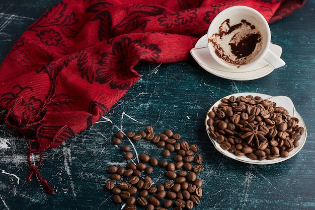 Une tasse de café vide avec des grains.