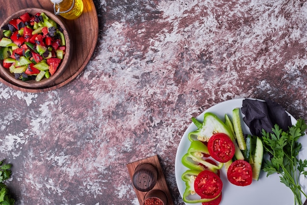 Une tasse de salade de légumes servie avec des épices et de l'huile.