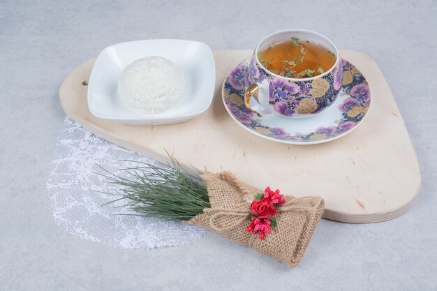 Tasse de thé et biscuit à la noix de coco sur planche de bois avec décoration de Noël. Photo de haute qualité