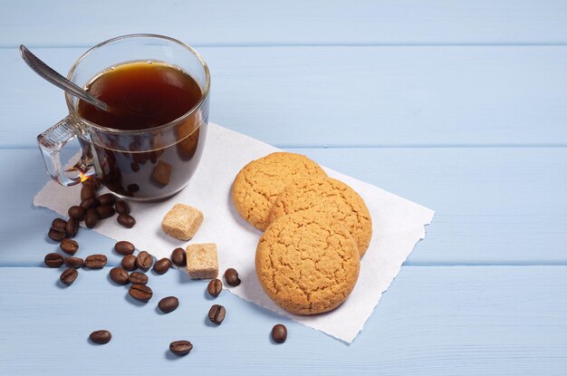 Tasse transparente de biscuits au café et à l'avoine sur une table en bois bleue