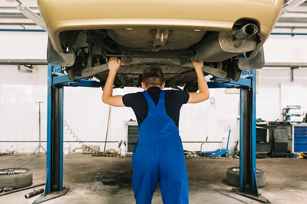 Technicien vérifiant la transmission de la voiture