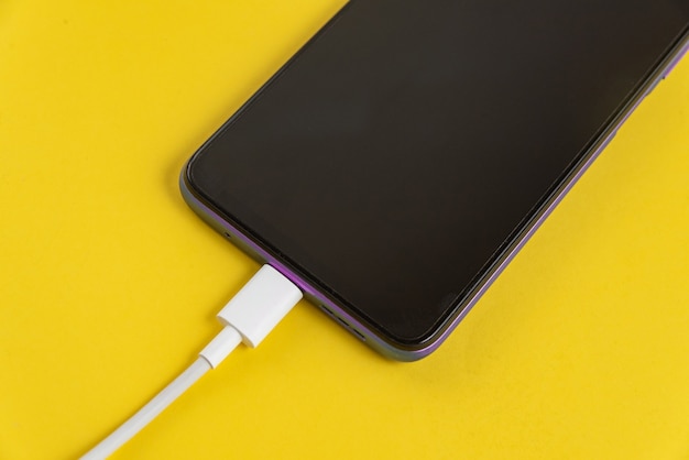 Téléphone portable bleu connecté au câble USB type C - Chargement