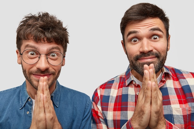 Tête de deux hommes heureux de garder les mains jointes