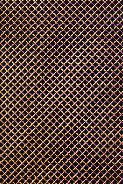 Photo gratuite texture de close-up de grille métallique d'un haut-parleur de musique dans un éclairage coloré