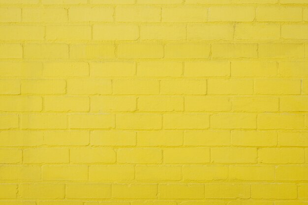 Texture de fond de mur en brique jaune