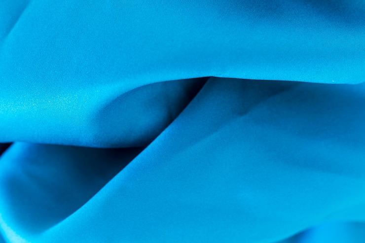 Photo gratuit texture matérielle de tissu bleu élégant lisse