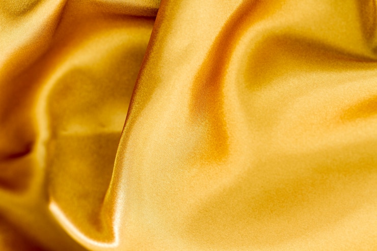 Photo gratuit texture matérielle de tissu doré élégant lisse