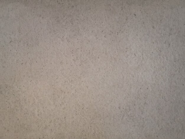 Texture de mur de ciment grunge beige abstrait.