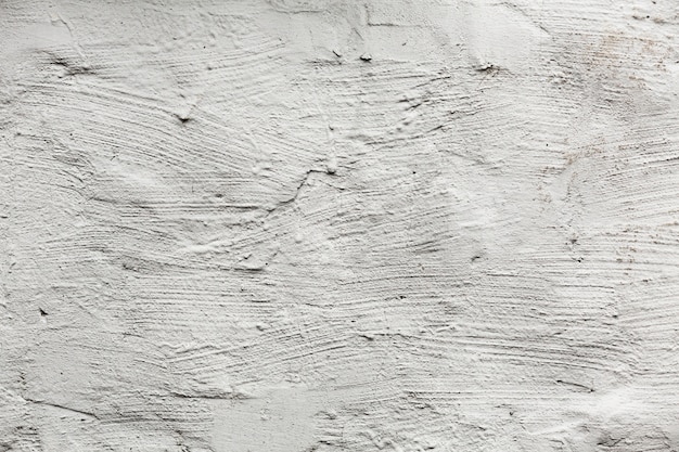 Texture de mur peint en blanc avec des fissures