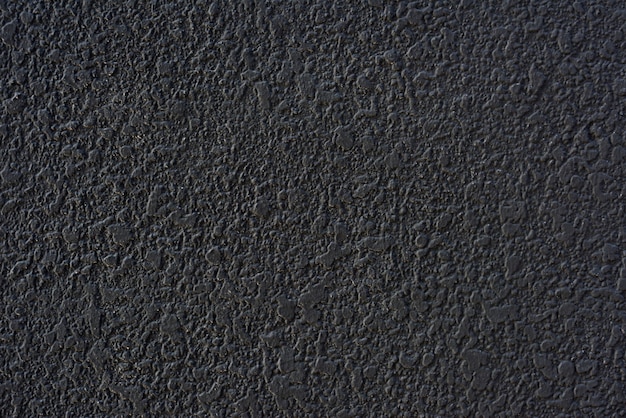 Texture de mur plâtré de ciment noir rugueux