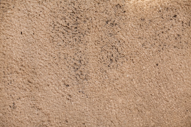 Texture de mur rugueuse avec des taches noires