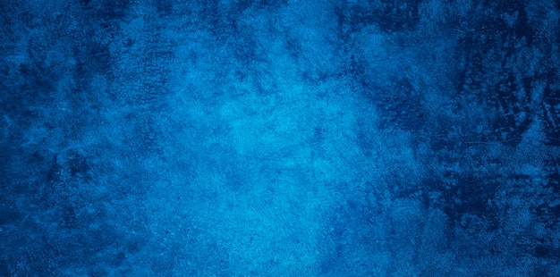 Texture de mur de stuc bleu marine relief décoratif abstrait grunge. Fond coloré rugueux grand angle
