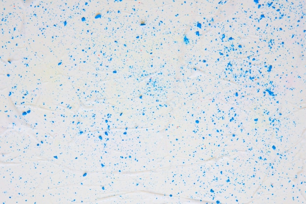 Texture de papier coloré avec des points bleus