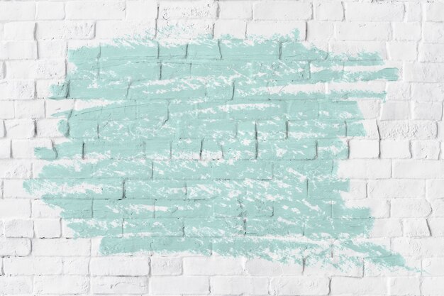 Texture de peinture à l'huile vert menthe sur un mur de briques blanches