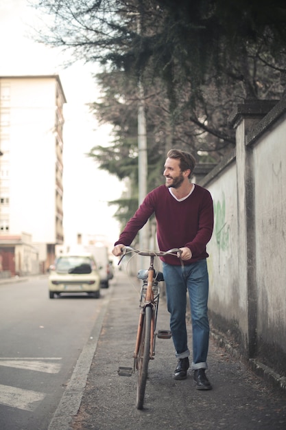 Tir vertical d'un jeune homme à vélo sur le trottoir