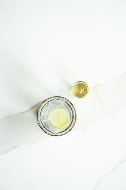 Tir vertical d'un verre de limonade sur une surface blanche