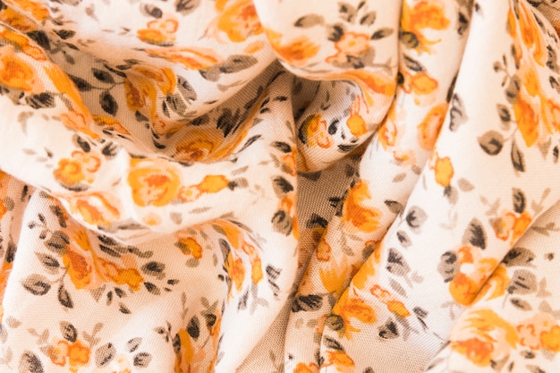 Photo gratuite toile de fond d'un tissu floral orange