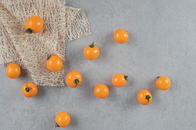 Tomates cerises jaunes isolés sur une table en béton.