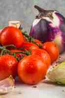 Photo gratuite tomates rouges fraîches; gousse d'ail; choux de bruxelles; aubergine sur une surface en bois