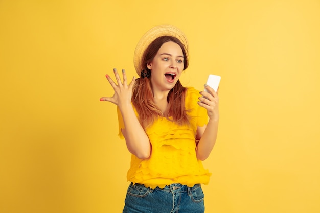 Étonné jeune femme à l'aide de smartphone